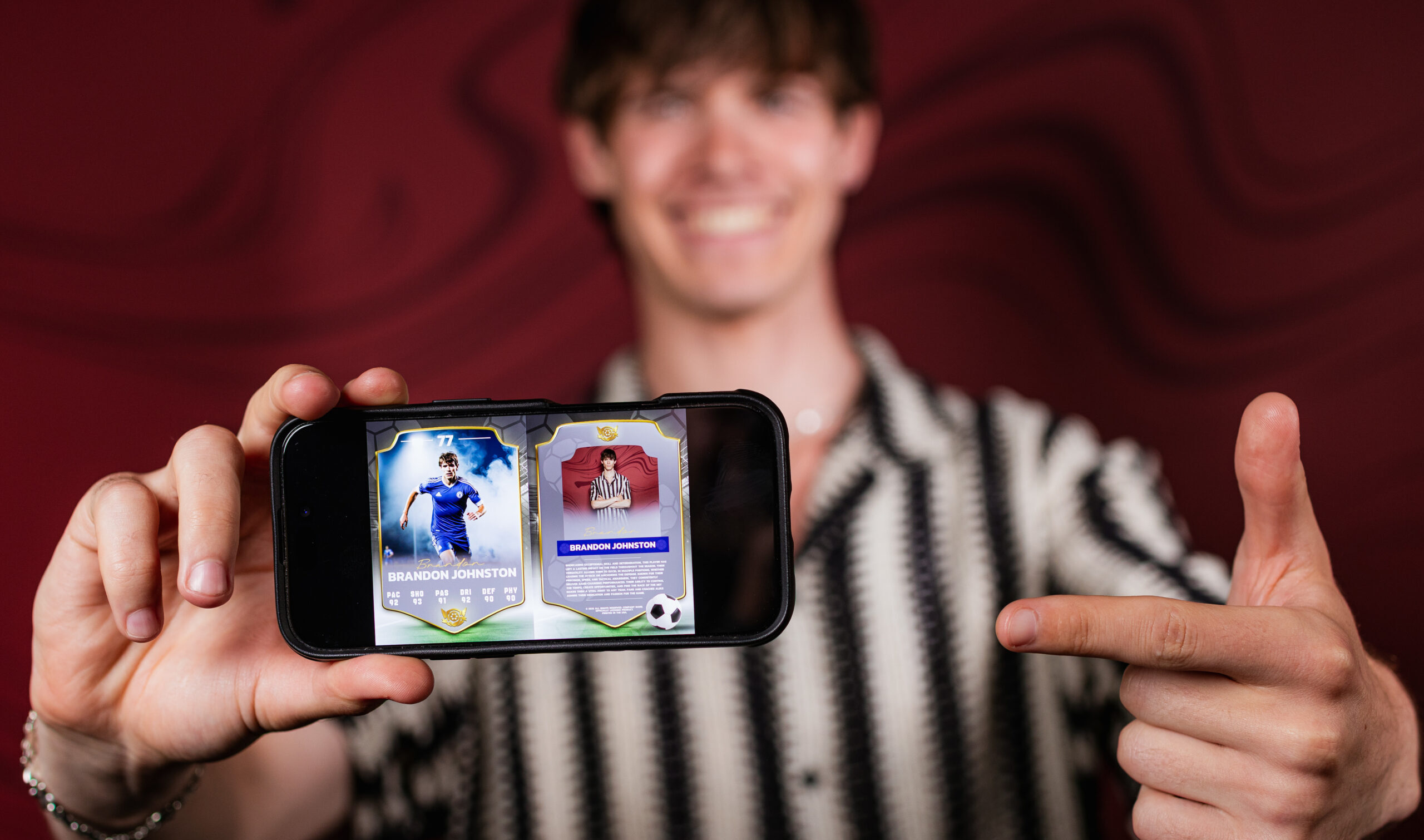 Guest holding a phone displaying his AI generated trading card