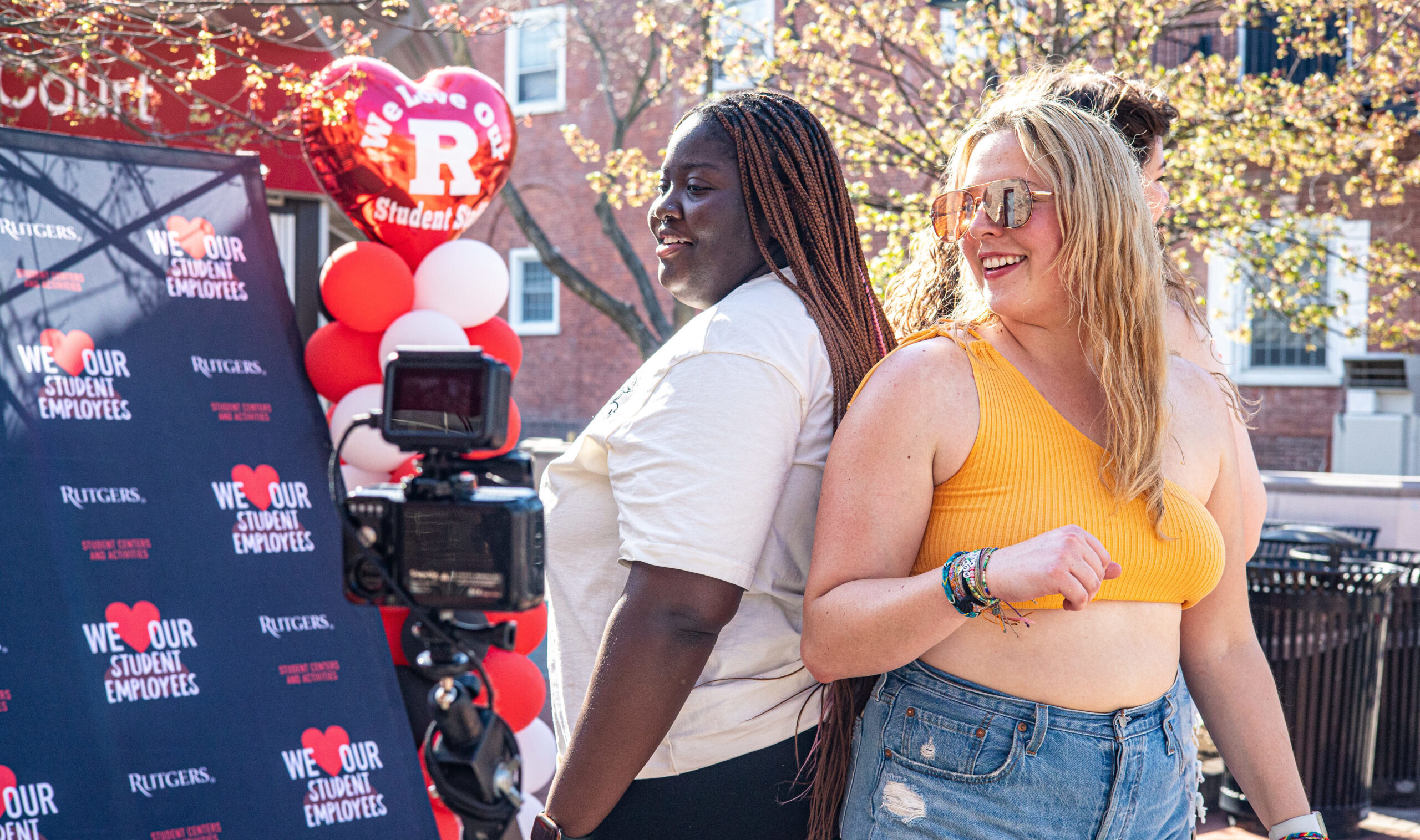 Guests posing together at an outdoor photo booth activation