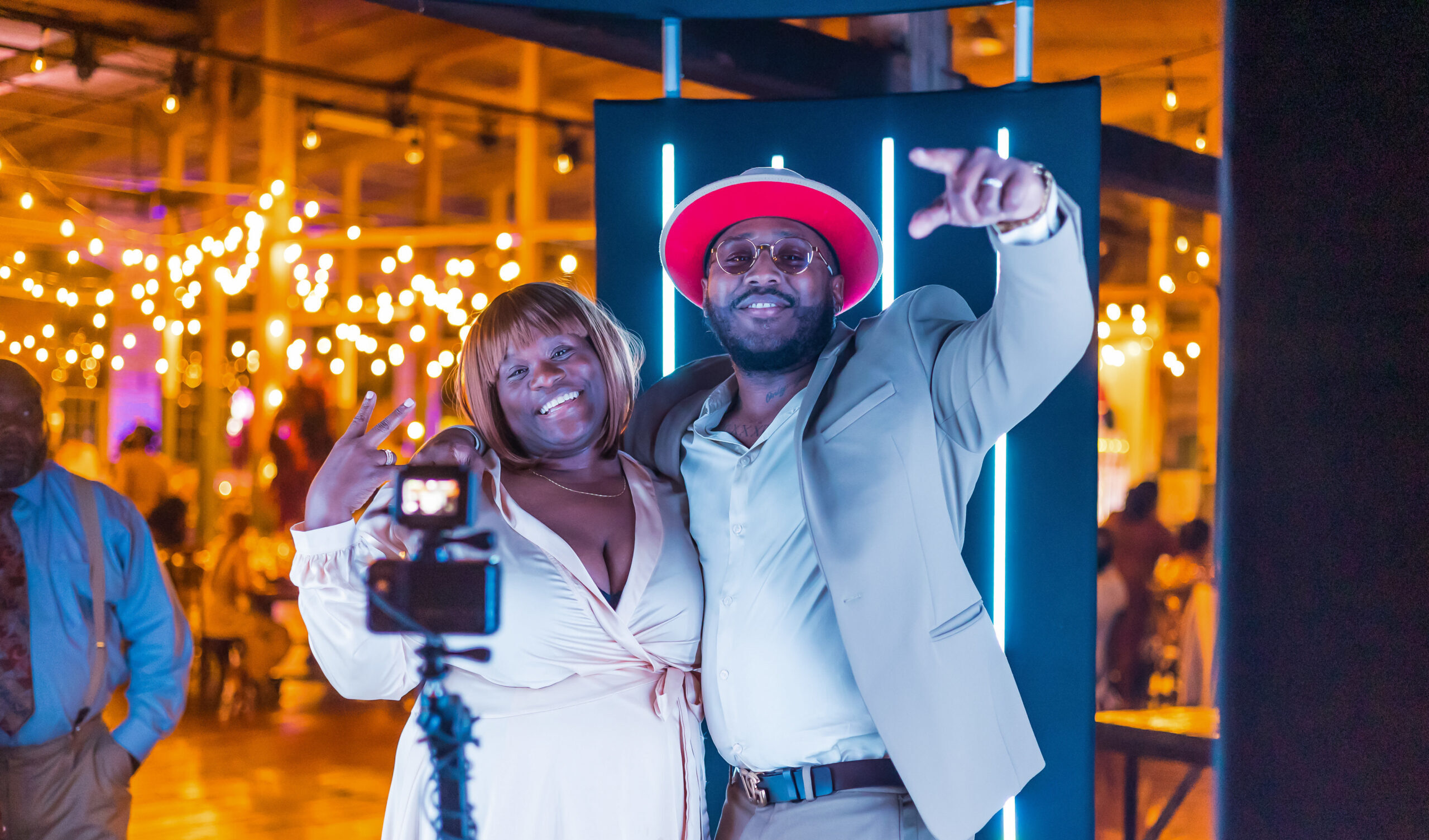 Guests posing with props at a festive photo booth