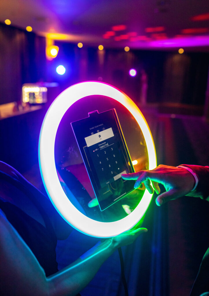 Neon ring light photo booth at an evening celebration
