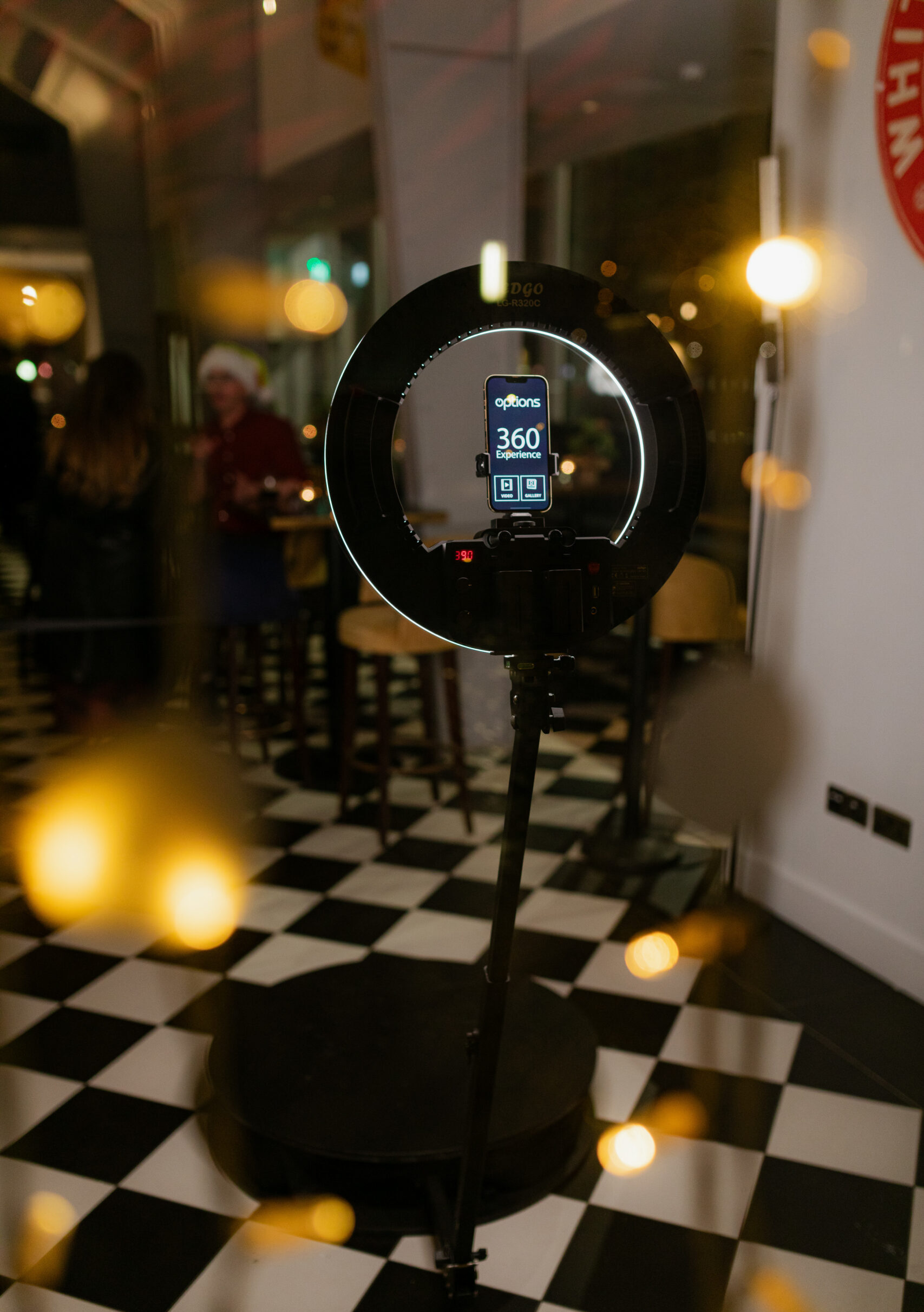 Round photo booth set up in a dimly lit venue