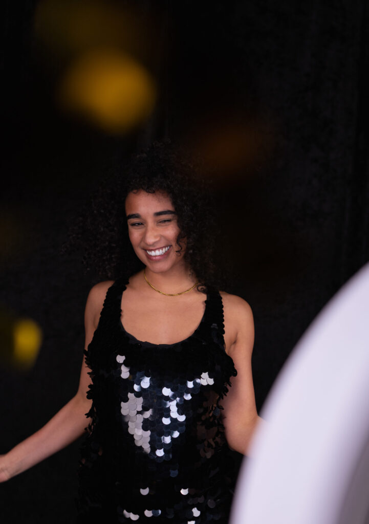 Guest in a sequin dress posing at an evening photo booth