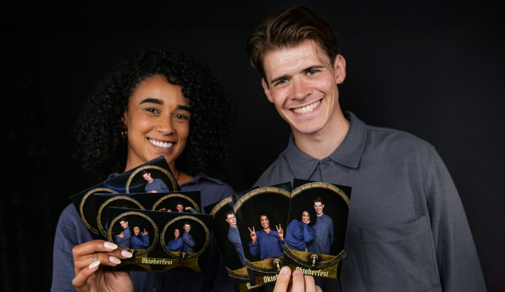 Guests holding heart shaped photo prints from the booth