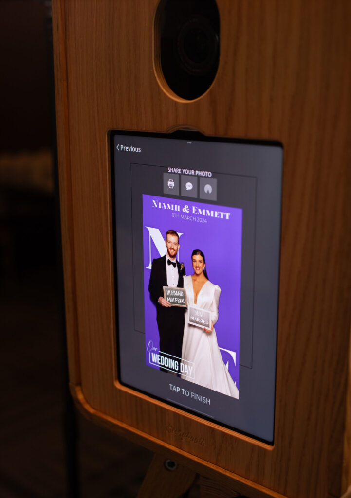 Photo booth screen showing a guest photo at a wedding