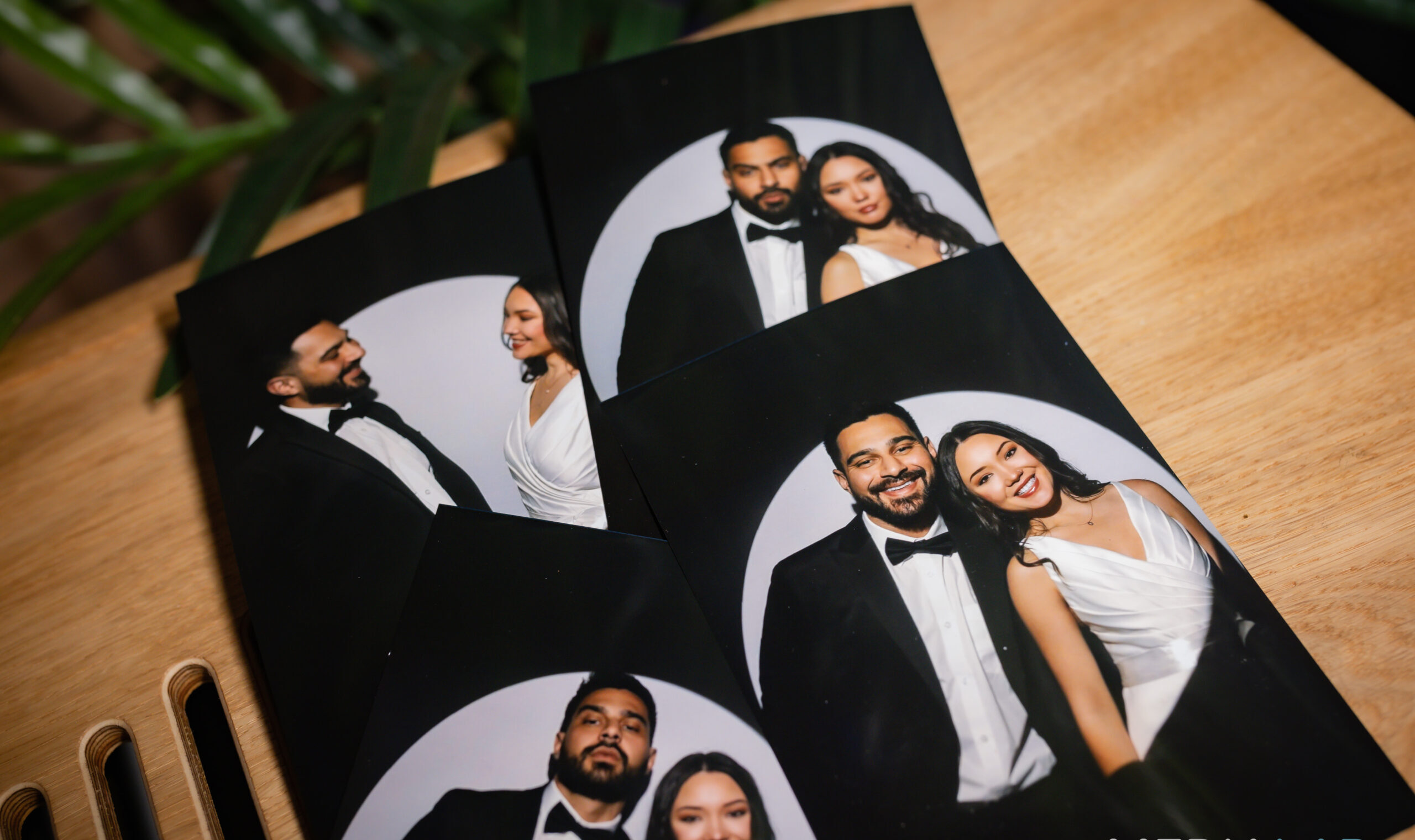 Wedding photo booth prints laid out on a table