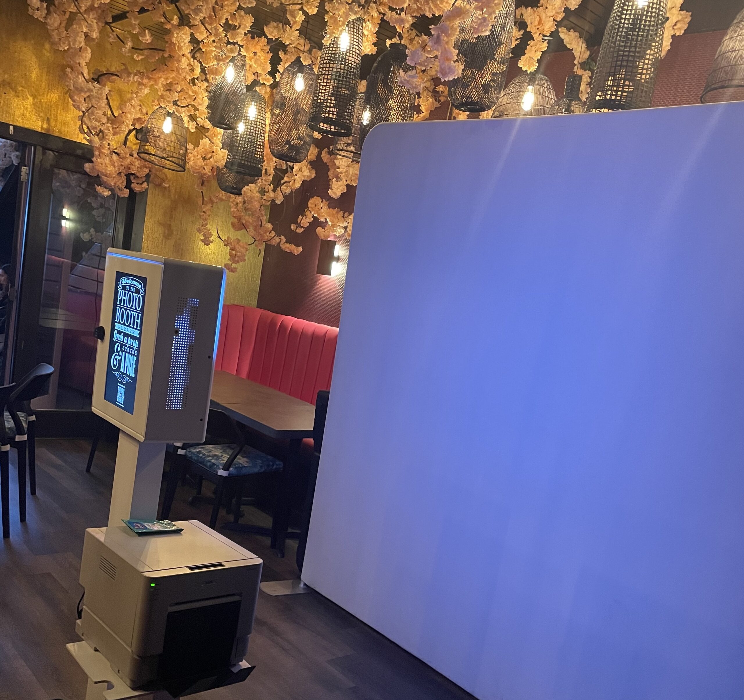 Photo booth glowing blue in a darkened event space