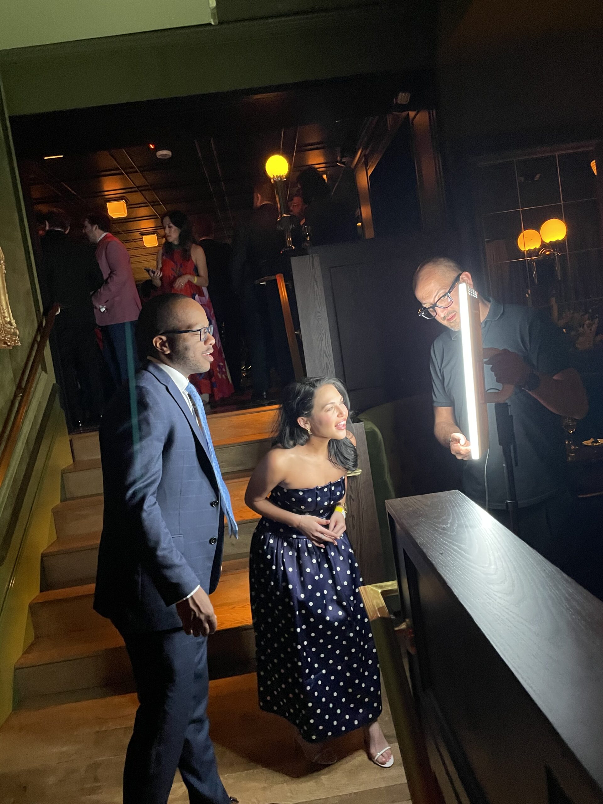 Guest using a photo booth at an evening reception