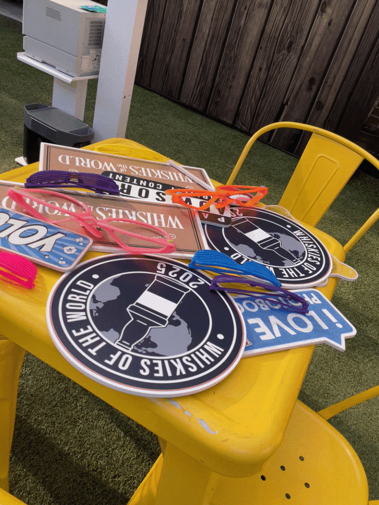 Custom printed keepsakes on a branded table at an event activation