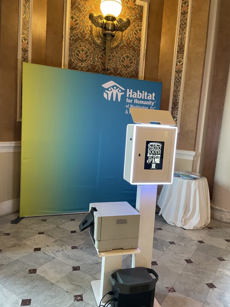 Photo booth set up in a hotel ballroom for a corporate event