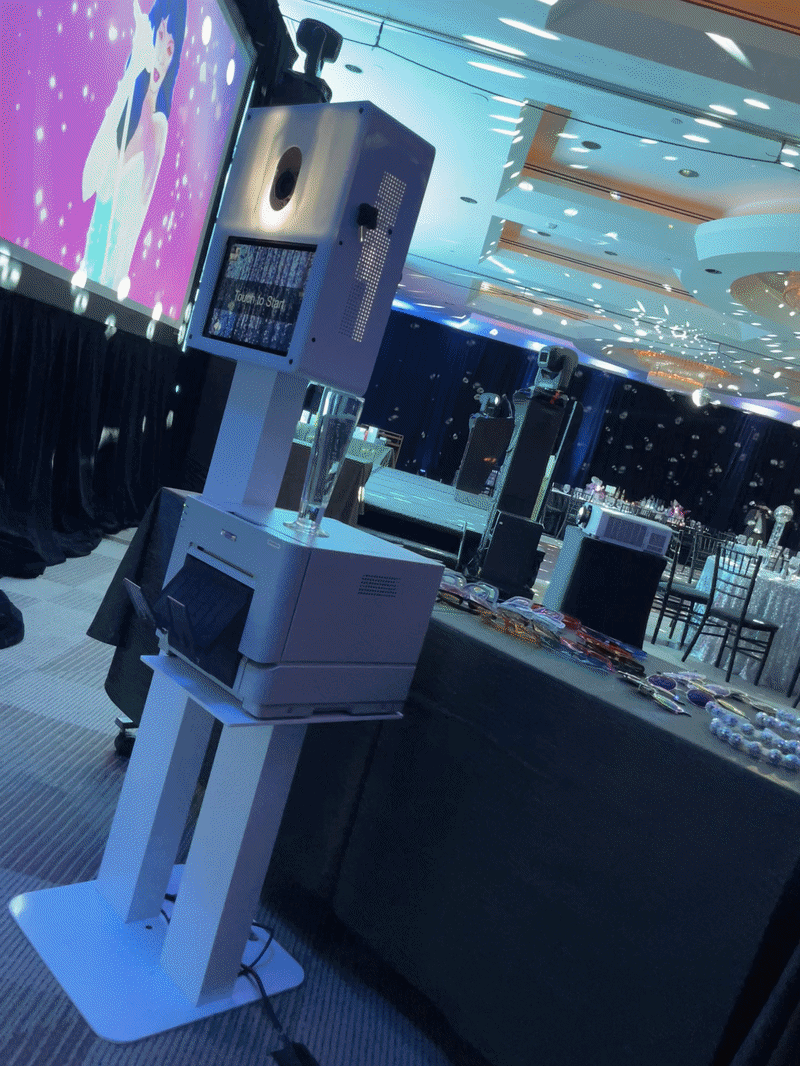 Photo booth with blue accent lighting at an evening event