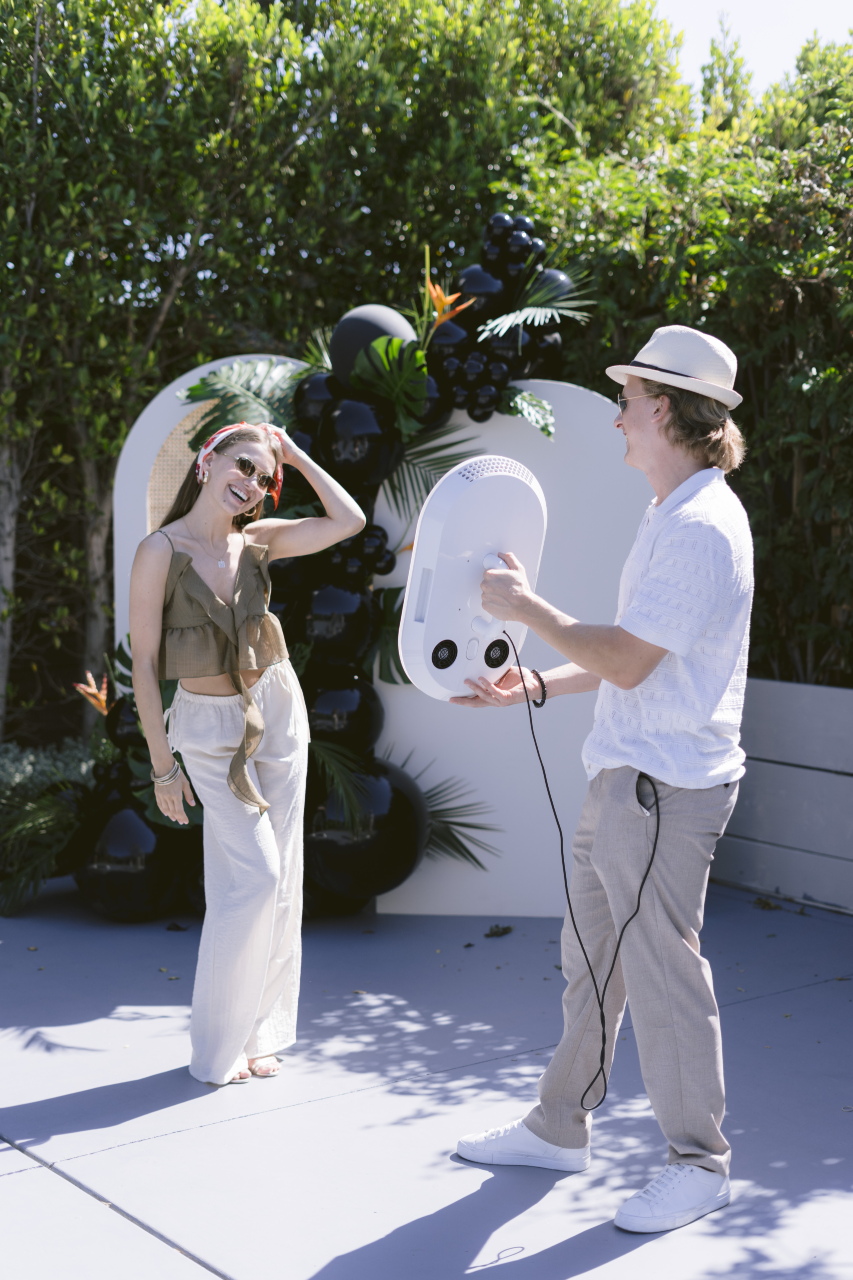 Guests walking to the photo booth at an outdoor launch event