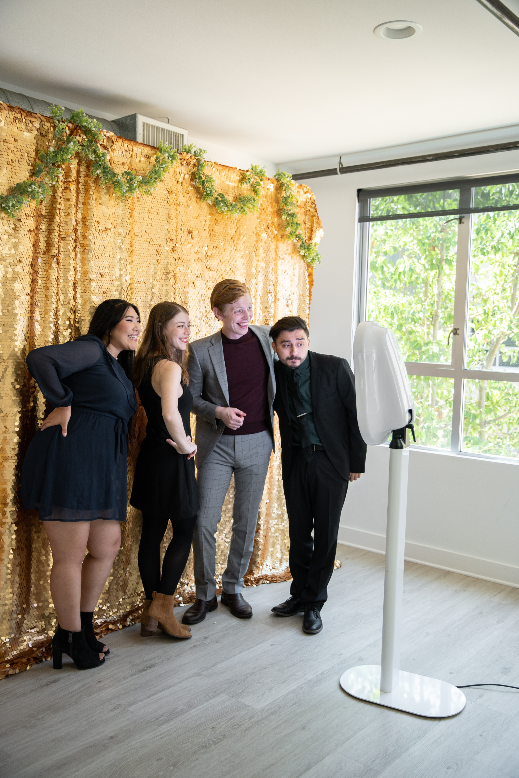 Guests gathered around a photo booth at a daytime event