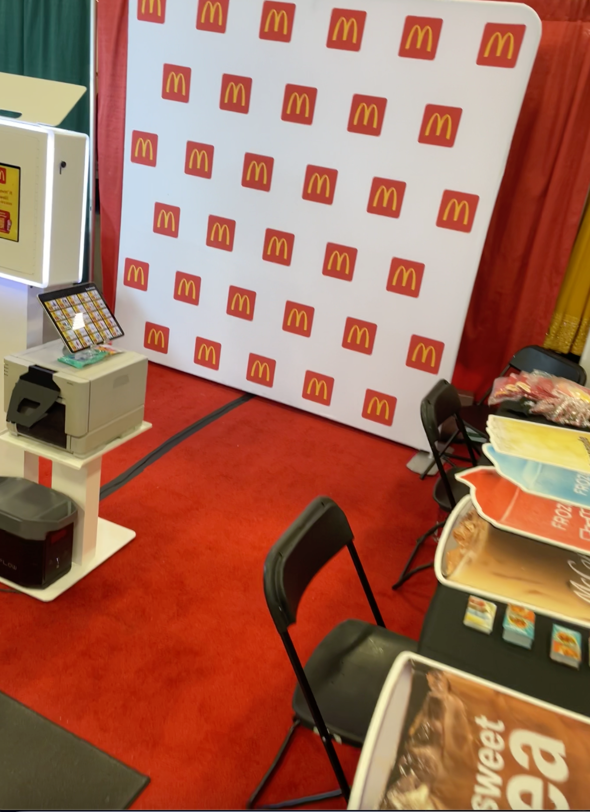 Branded photo booth with a red step and repeat backdrop at an event