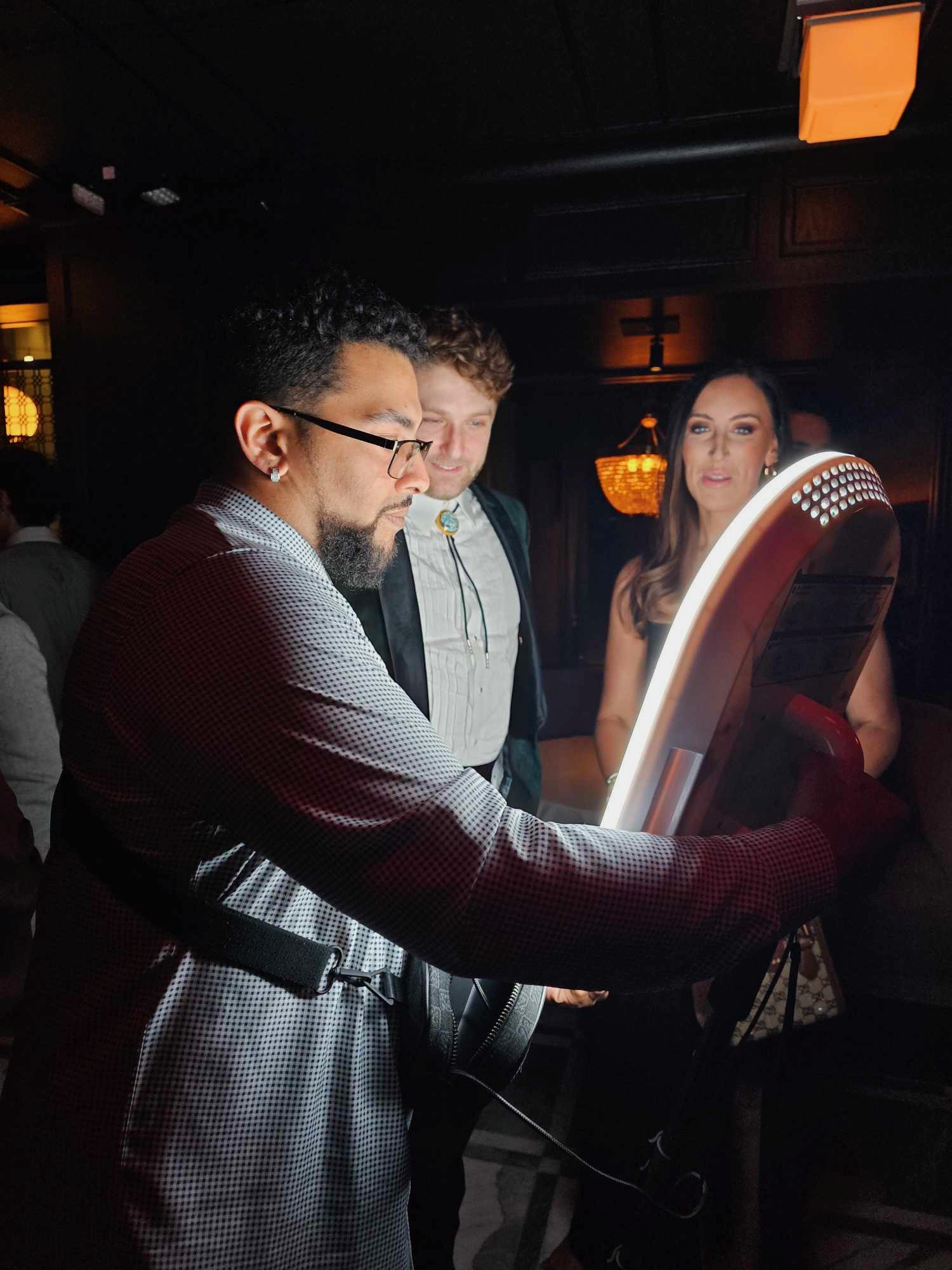 Attendant using a handheld roaming photo booth at an event