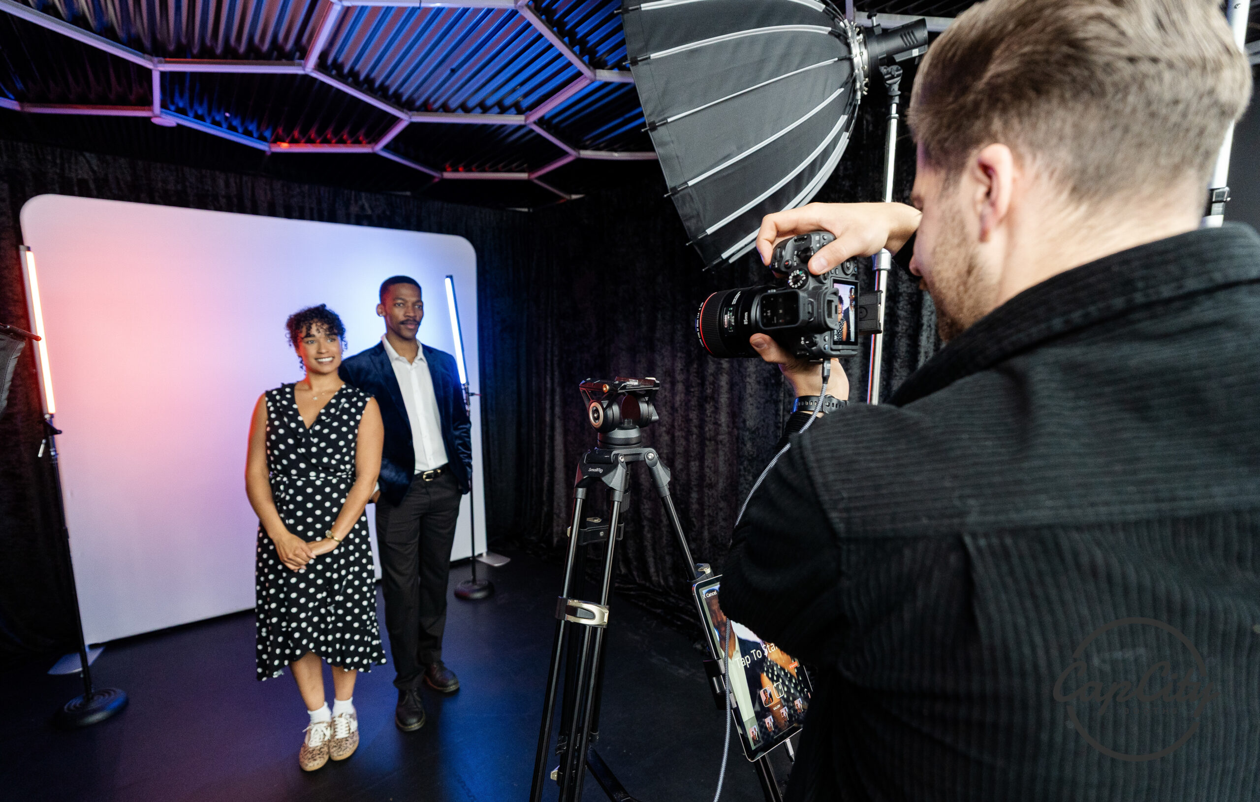 Guest photographed in a studio style booth with professional lighting