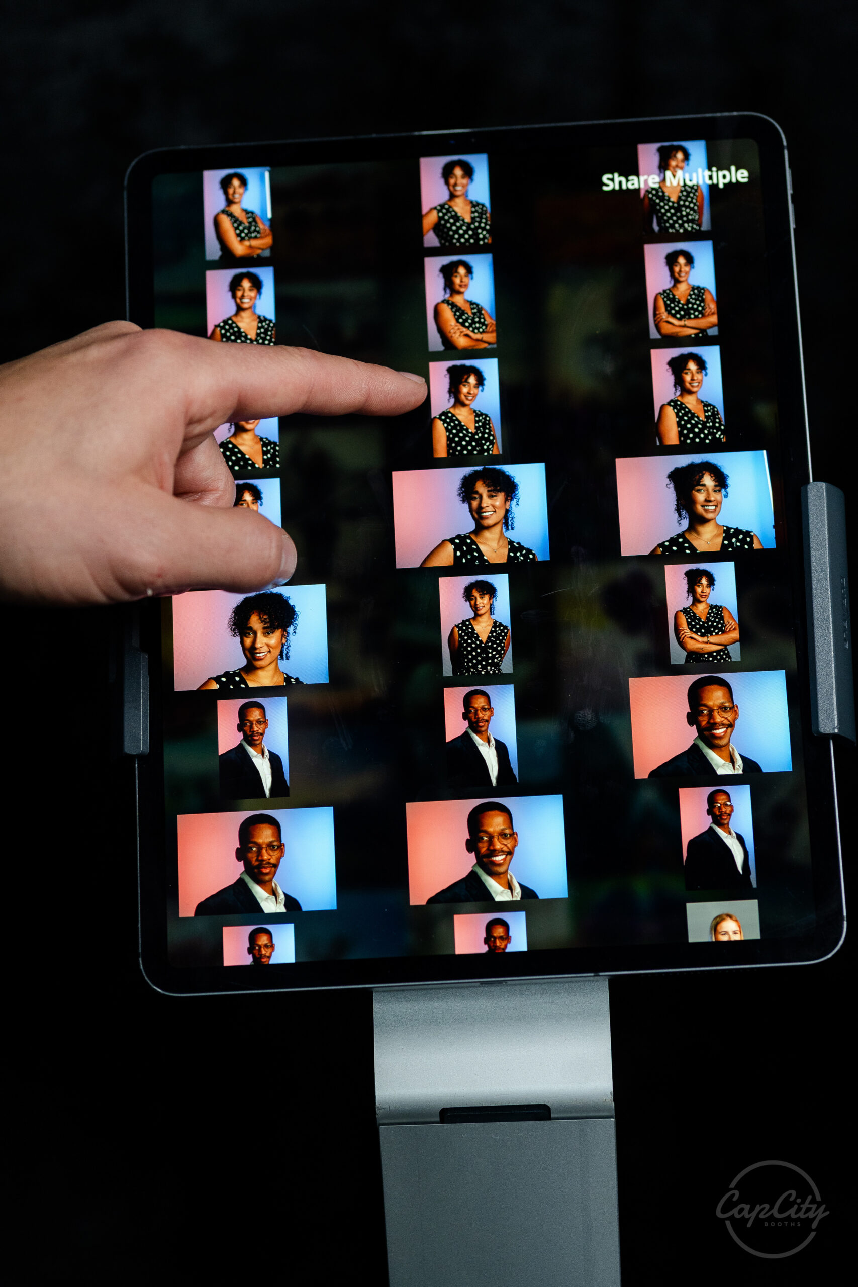 Guest selecting photos on the touchscreen of a digital photo booth