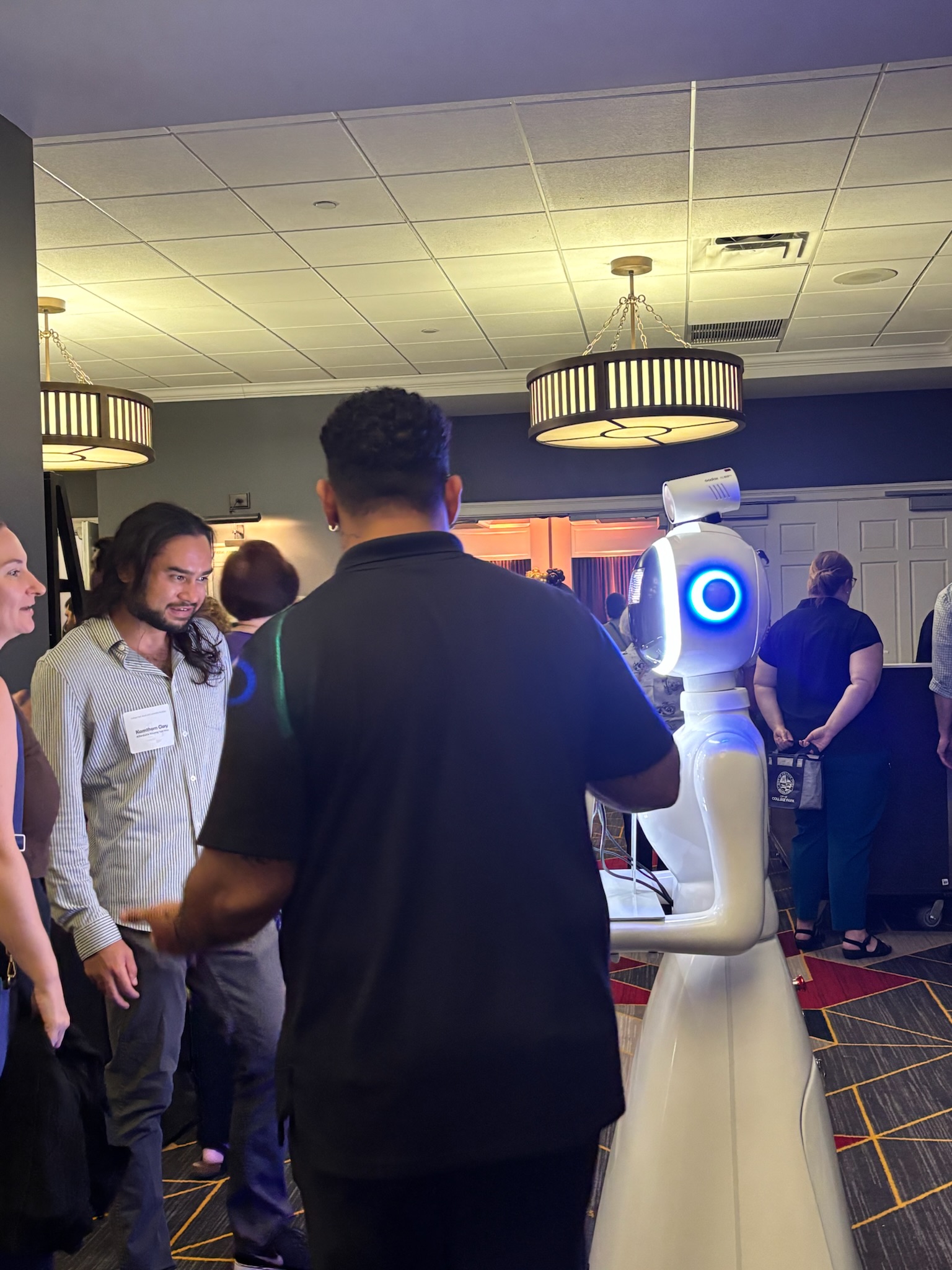 Guests interacting with the robot photo booth at a conference